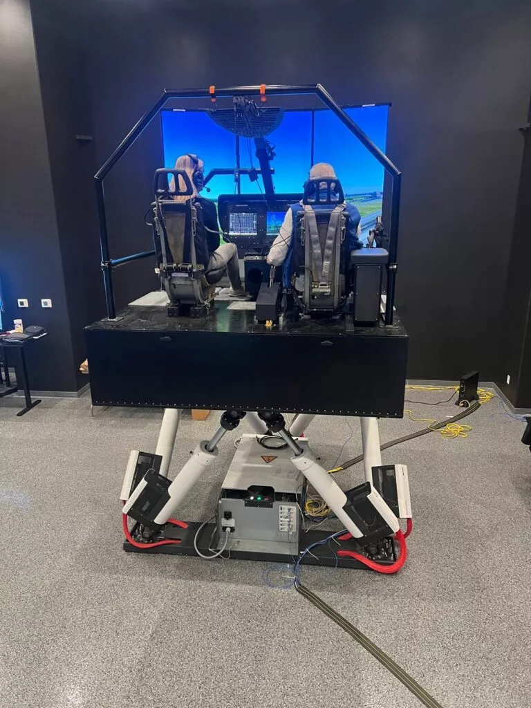 Two pilots training in flight simulator.