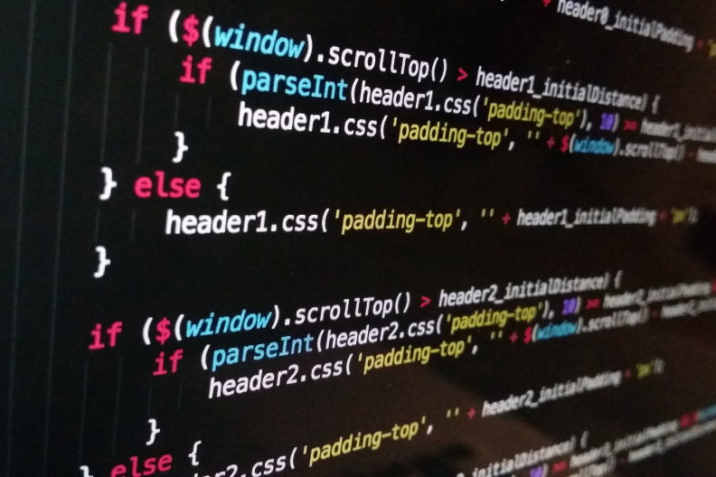 Close-up of colorful JavaScript code on a dark screen.